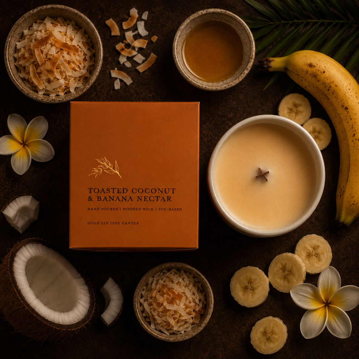 A styled flat-lay of a candle in a white bowl next to its orange box labeled 'TOASTED COCONUT & BANANA NECTAR,' surrounded by coconut pieces, sliced bananas, flowers, and a banana on a dark background.