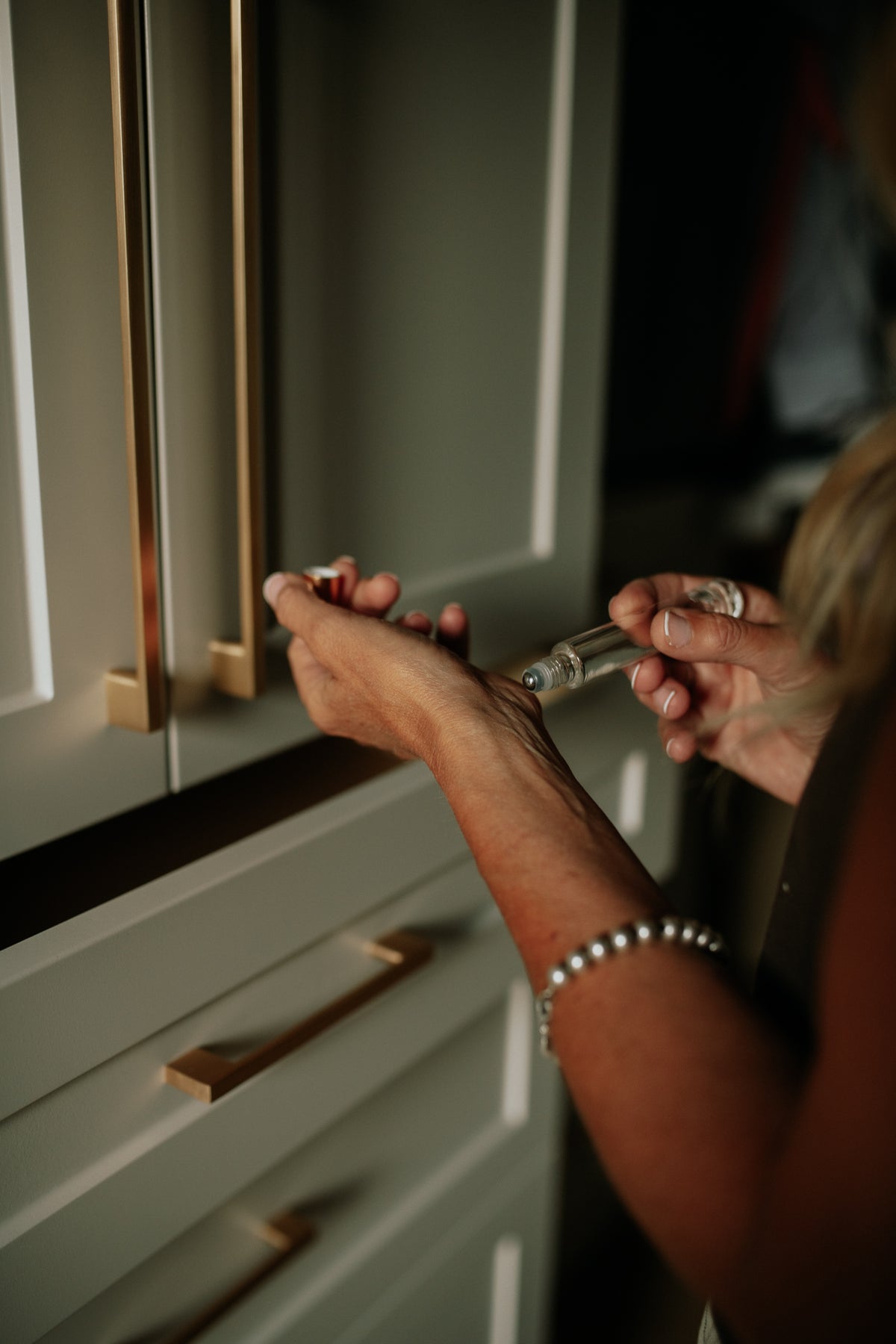 Woman putting on Woodsy Roll On Perfume